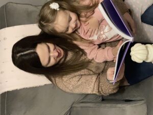 Mom and daughter reading from a storybook