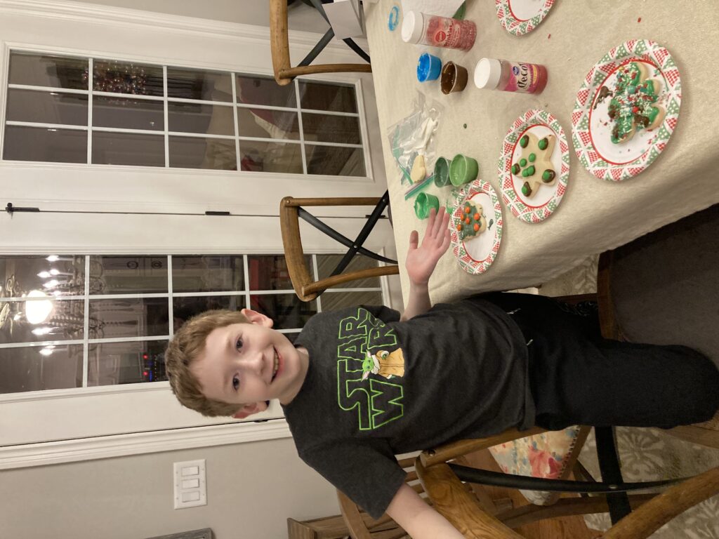 Boy decorating Christmas Cookies